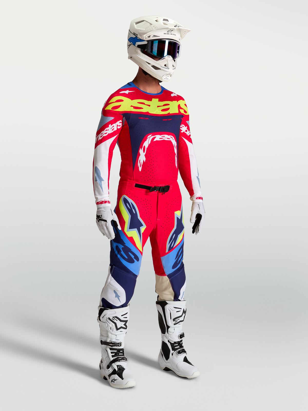 Alpinestars Supertech Dyna Pants, Fire Red and Navy Blue motocross gear set including racing jersey and white boots for men.