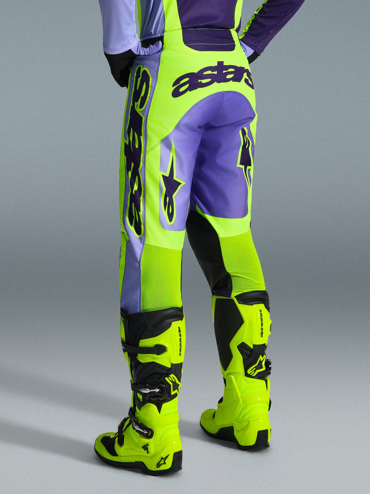 Alpinestars 2026 Racer Portl Pants, Motocross Pants, Purple and Yellow Fluo, back view featuring bold astars branding and purple accents, worn with matching fluo yellow motocross boots, durable synthetic material for off-road racing