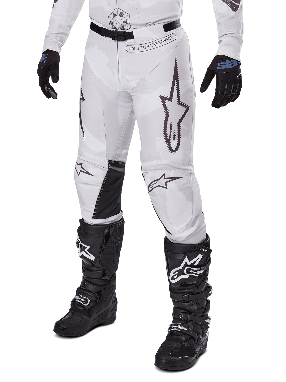 Alpinestars 2025 Racer Hollow Pants, Motocross Pants, White and Grey Camo, featuring large black outlined star logos and black leather inner knee panels, worn with black motocross boots and gloves, durable design for off-road racing.