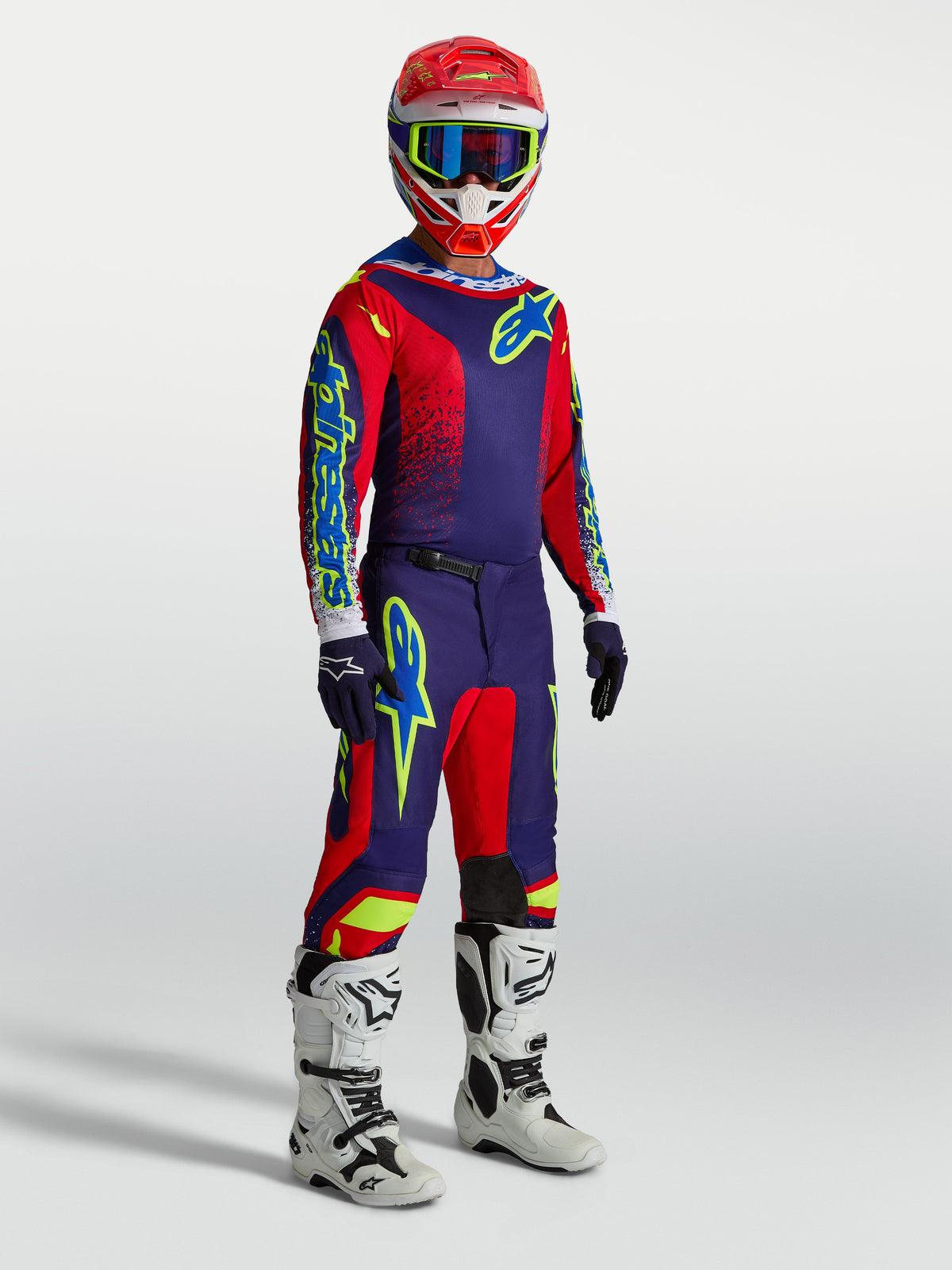 Alpinestars Men's Fluid Drag Gear Set, navy blue and red motocross outfit with white racing boots.