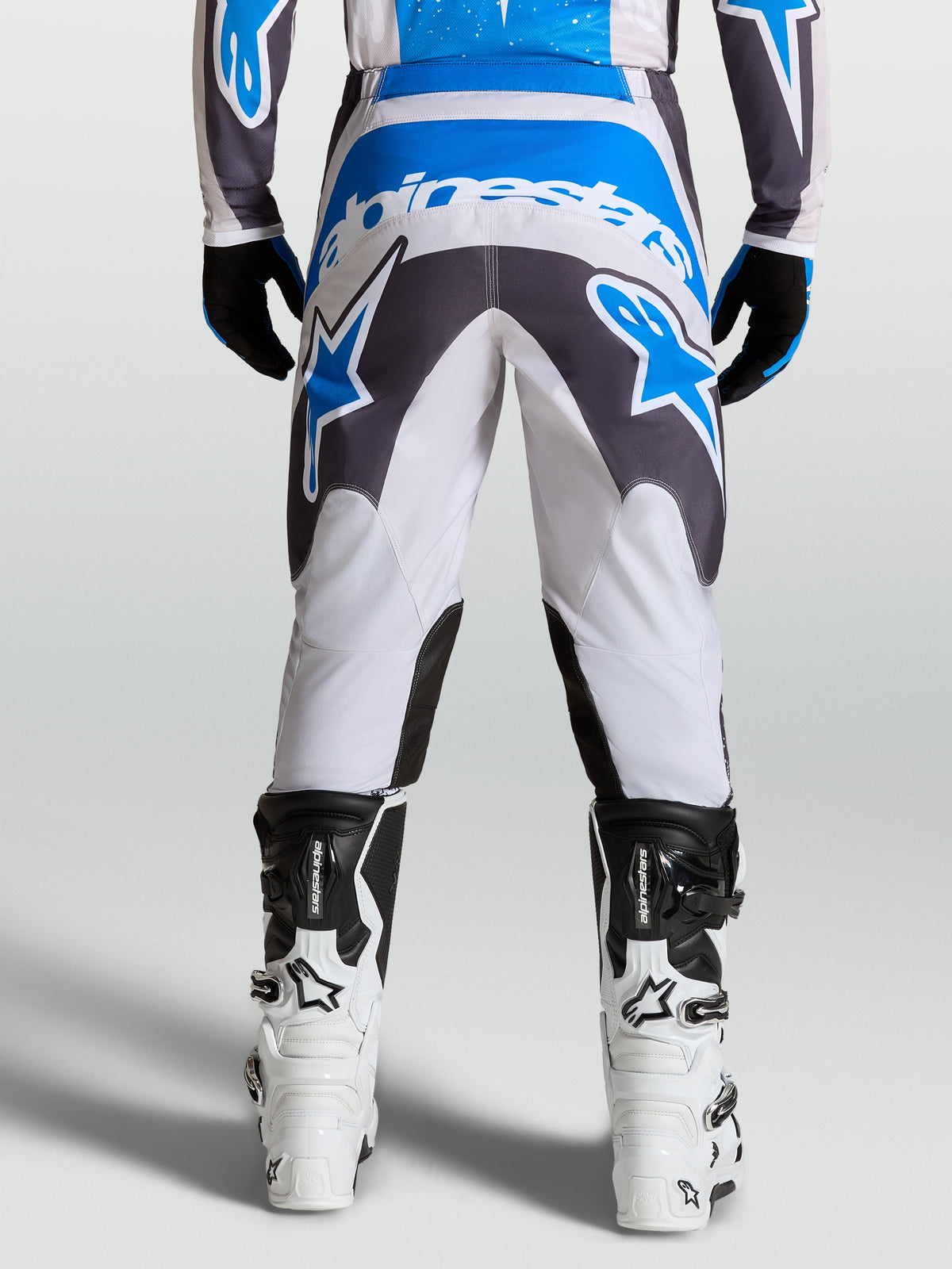Alpinestars Fluid Drag Pants, men's motocross gear in graystone and blue, featuring a reinforced seat for off-road riding.