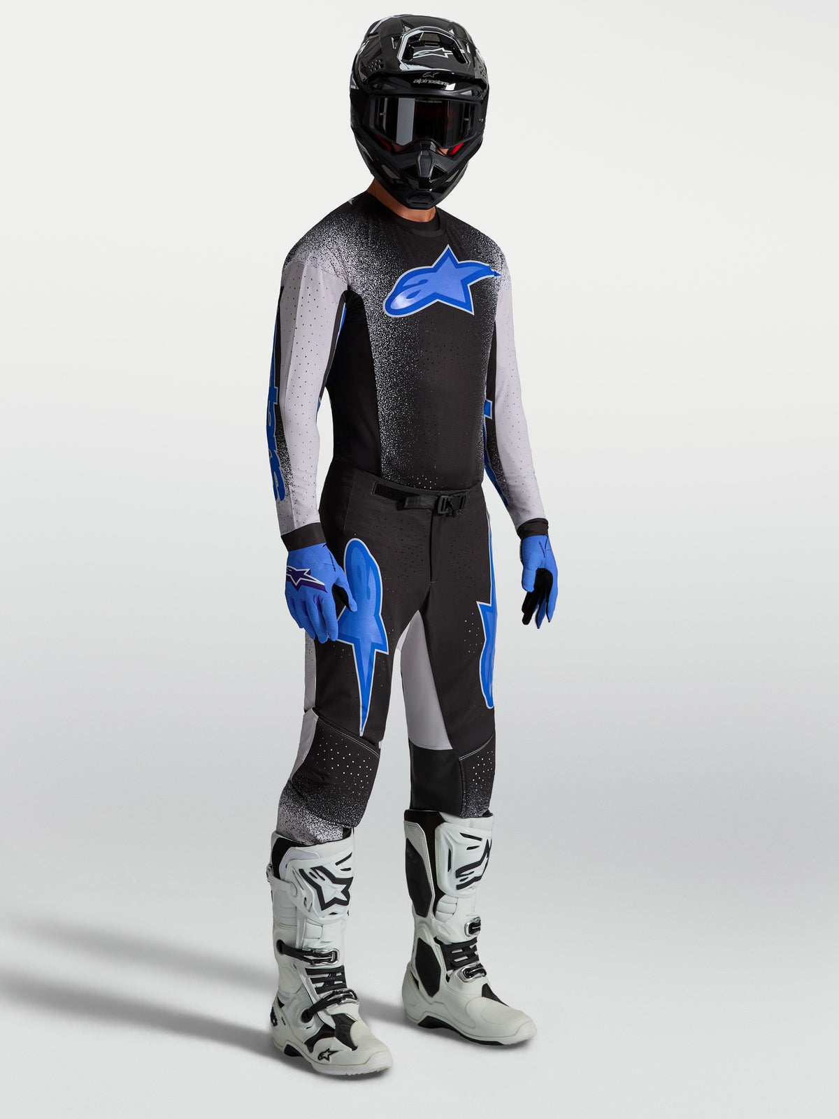 Alpinestars Supertech Hiten AFD Jersey and Gear Set, black and blue motocross kit with white racing boots.