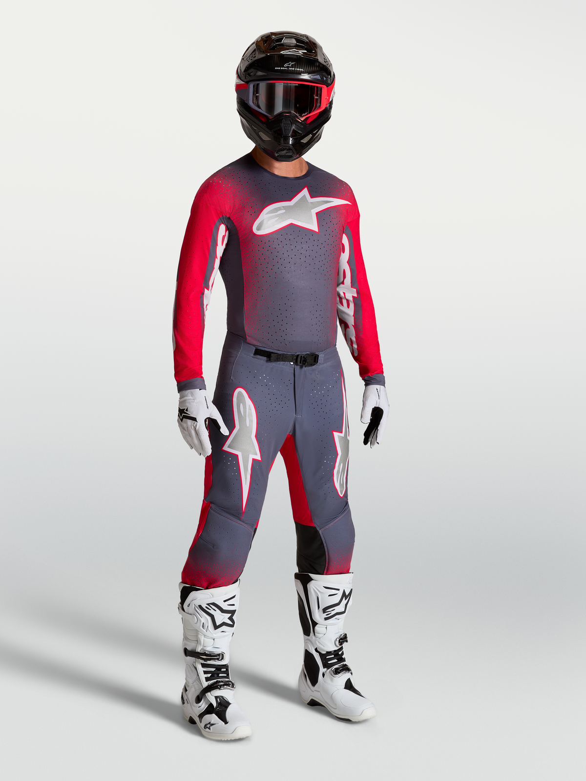 Alpinestars Supertech Hiten AFD Jersey, on-model motocross gear in graystone and red fluo, featuring a lightweight athletic fit and stretch mesh for professional MX performance.