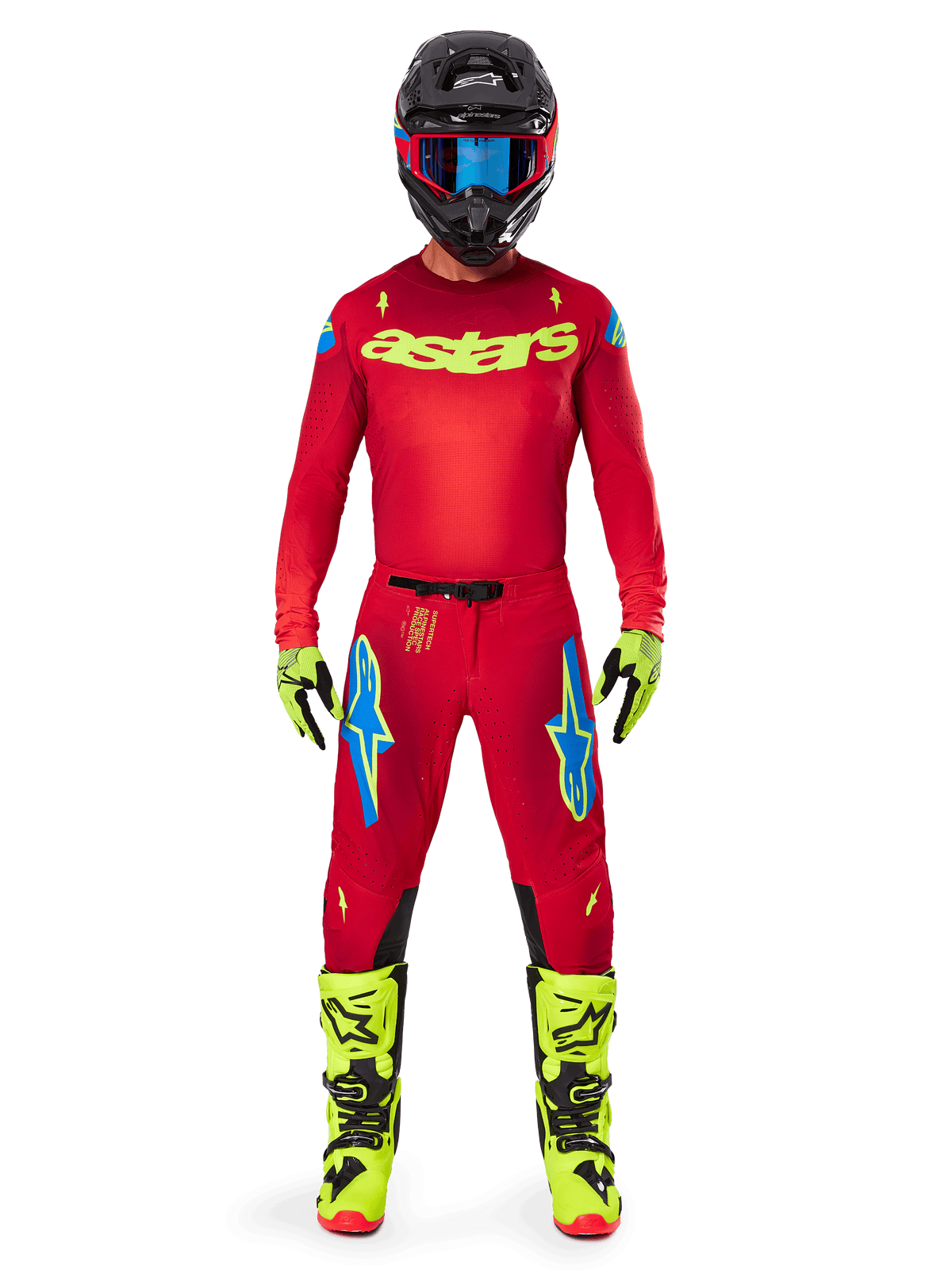 Motocross rider wearing the Alpinestars 2025 Supertech Maker Jersey and matching pants in Bright Red and Yellow Fluo, featuring yellow 'astars' branding on the chest, black helmet with blue goggles, yellow-fluo gloves and boots, complete professional racing outfit for off-road performance.