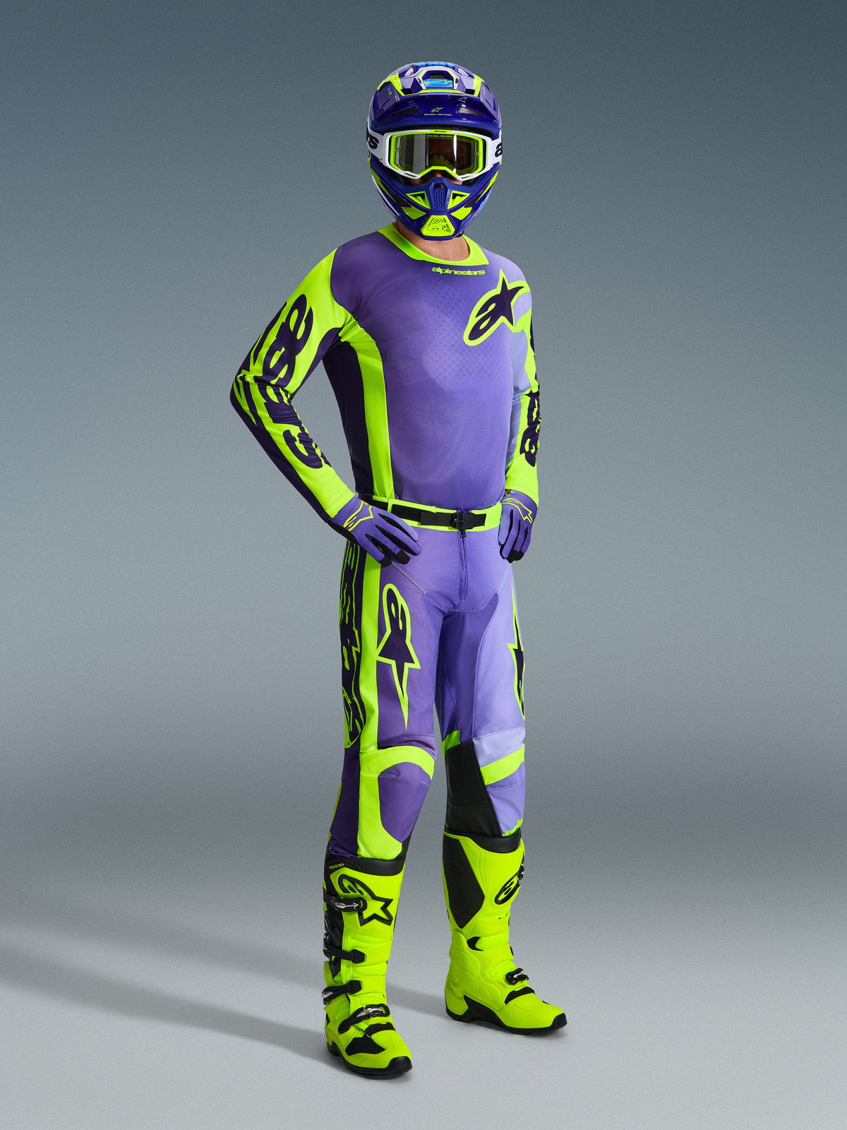 Alpinestars 2026 Racer Portl Gear Set, complete motocross racing outfit, purple and fluorescent yellow jersey with neon yellow sleeves, matching purple and neon yellow pants, fluorescent yellow boots, purple and yellow helmet with yellow goggles, coordinated professional gear for off-road riding