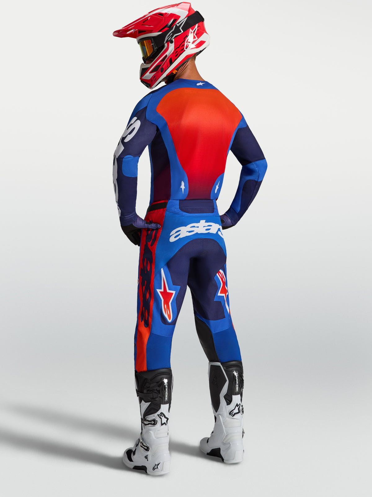 Alpinestars 2027 Racer Hunt Gear Set, blue and red motocross jersey and pants, rear view of rider wearing off-road gear with breathable mesh and race fit.