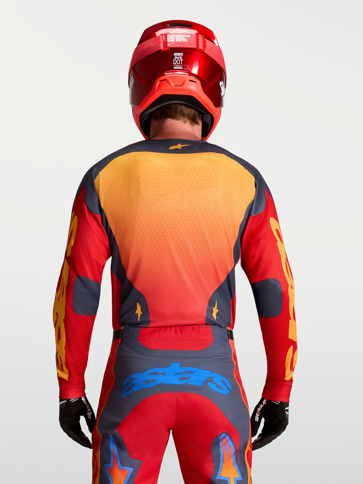 Alpinestars Racer Hunt Jersey, men's motocross racing gear in Fire Red and Graystone with yellow and blue accents, rear view on model.