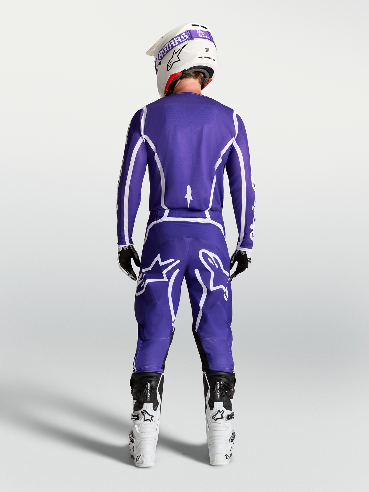Alpinestars Fluid Apex V2 Jersey in Deep Blue and White, rear view on rider with matching motocross pants and white boots.