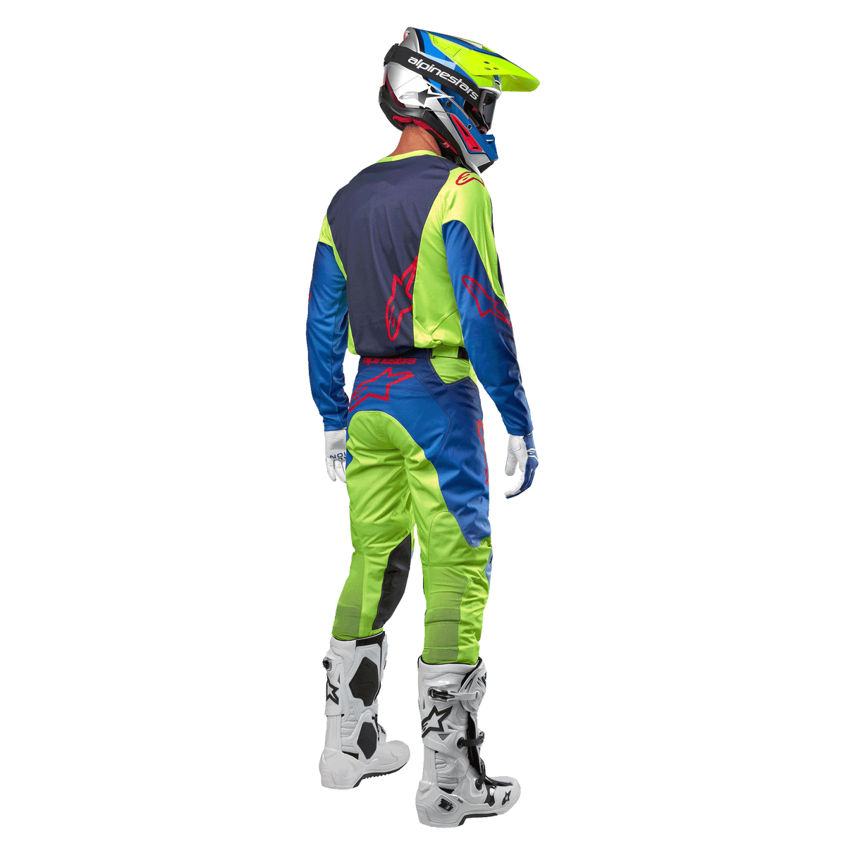 Motocross rider from behind wearing the Alpinestars 2024 Racer Hoen Jersey in Yellow Fluo and Blue Night Navy, matching motocross pants and white boots, showing the rear design with red logos, coordinated outfit for professional off-road racing