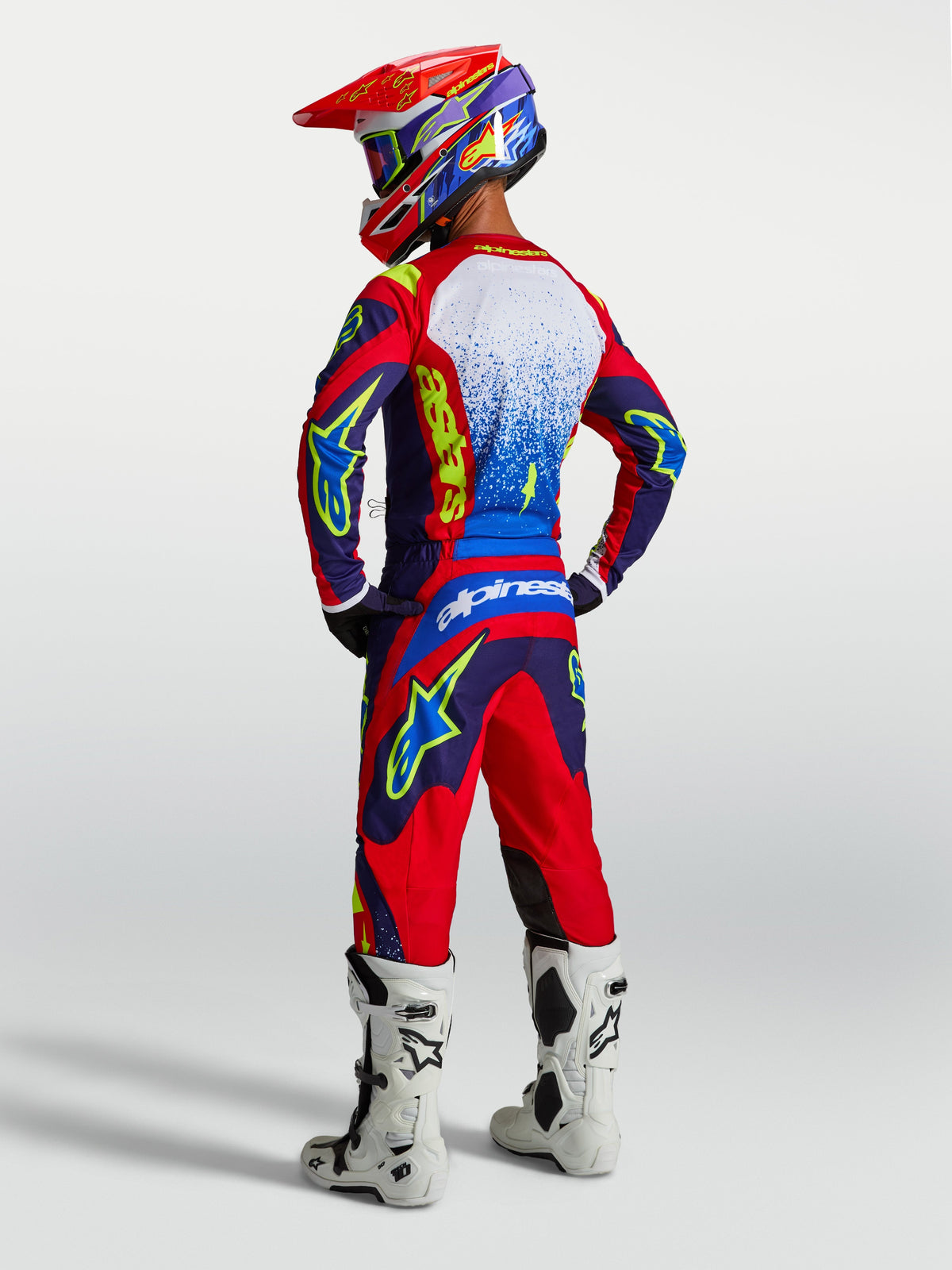Alpinestars Fluid Drag Jersey, Blue and Red Motocross Top, Men's on-model rear view with matching gear and white boots.