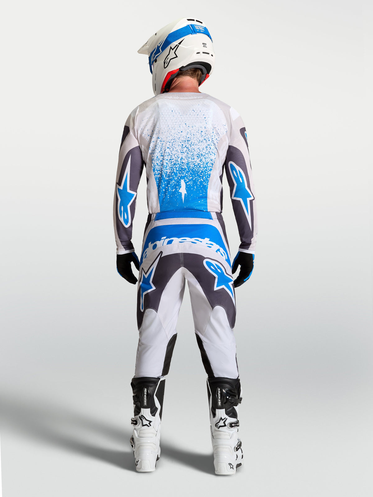 Alpinestars 2027 Fluid Drag Gear Set, Men's Motocross Jersey and Pants in White, Gray, and Blue, Rear View.