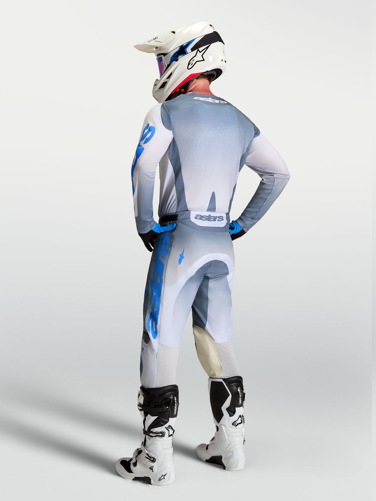 Alpinestars Racer Amber Pants and 2027 Gear Set, motocross racing apparel, gray and blue, rear view on a rider.