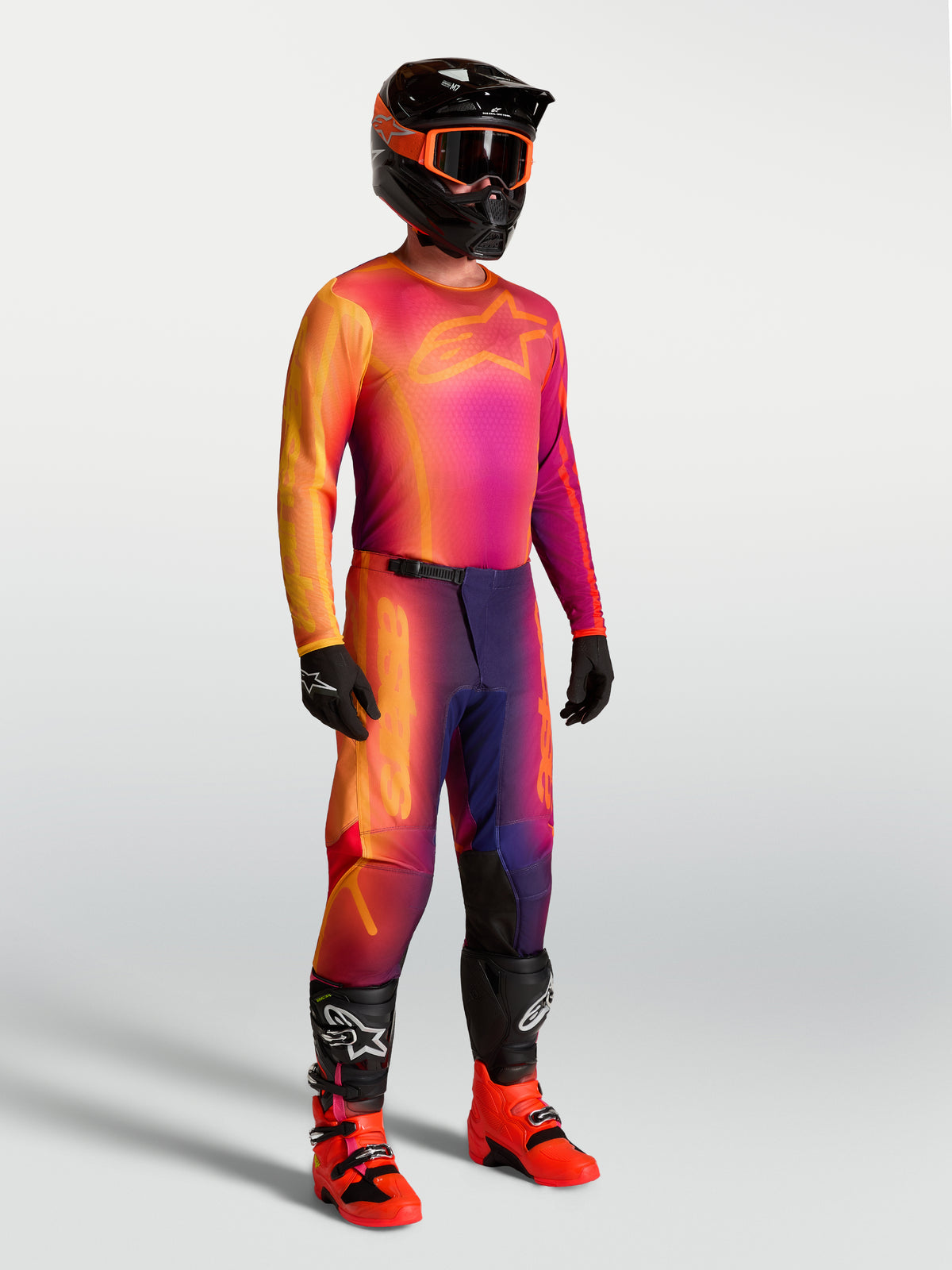 Alpinestars Fluid Kepler Jersey, purple and orange motocross jersey on-model with matching racing gear.