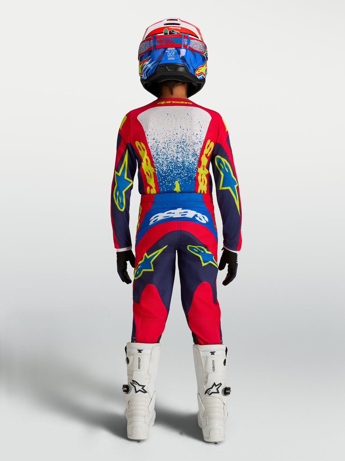Alpinestars 2027 Youth Fluid Drag Jersey, Navy Blue and Fire Red motocross gear, rear view on rider with matching pants.
