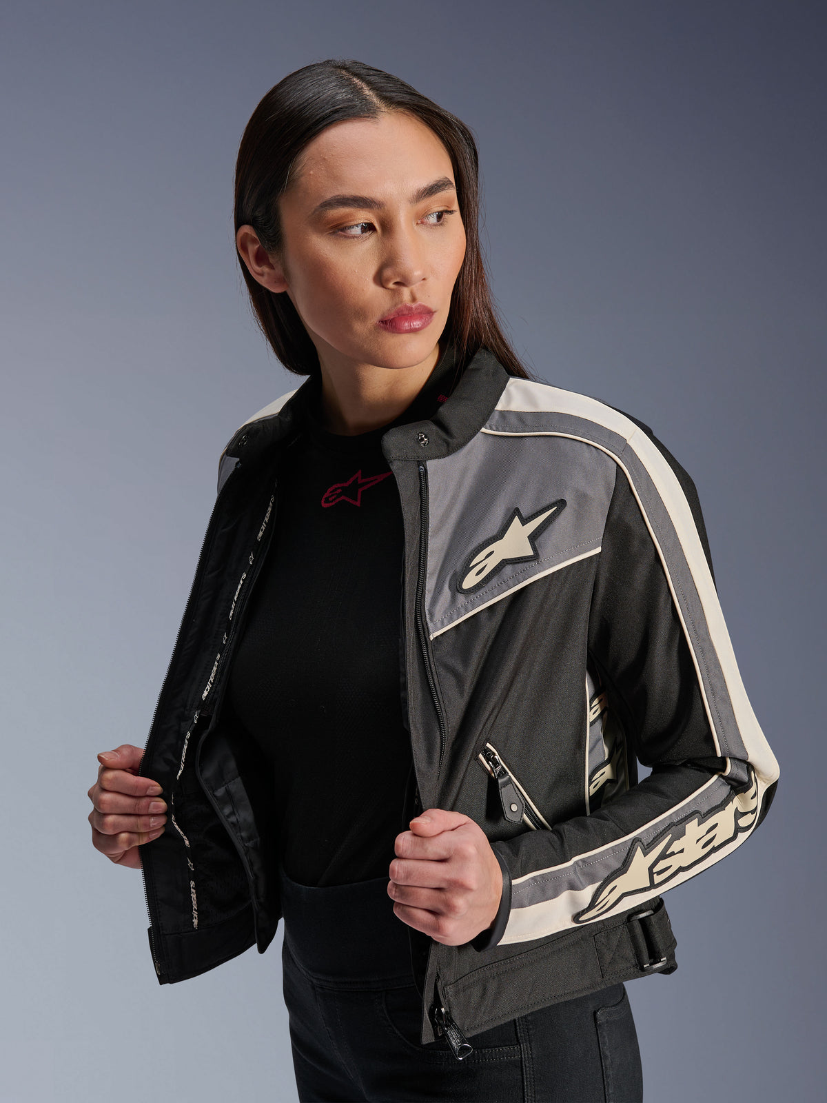Alpinestars Woman Stella T-Dyno WR Jacket, textile motorcycle jacket, Black Dark Gray and Ecru, vintage-inspired design with sporty stripes and logos on chest and sleeves, worn by a model, urban road riding gear