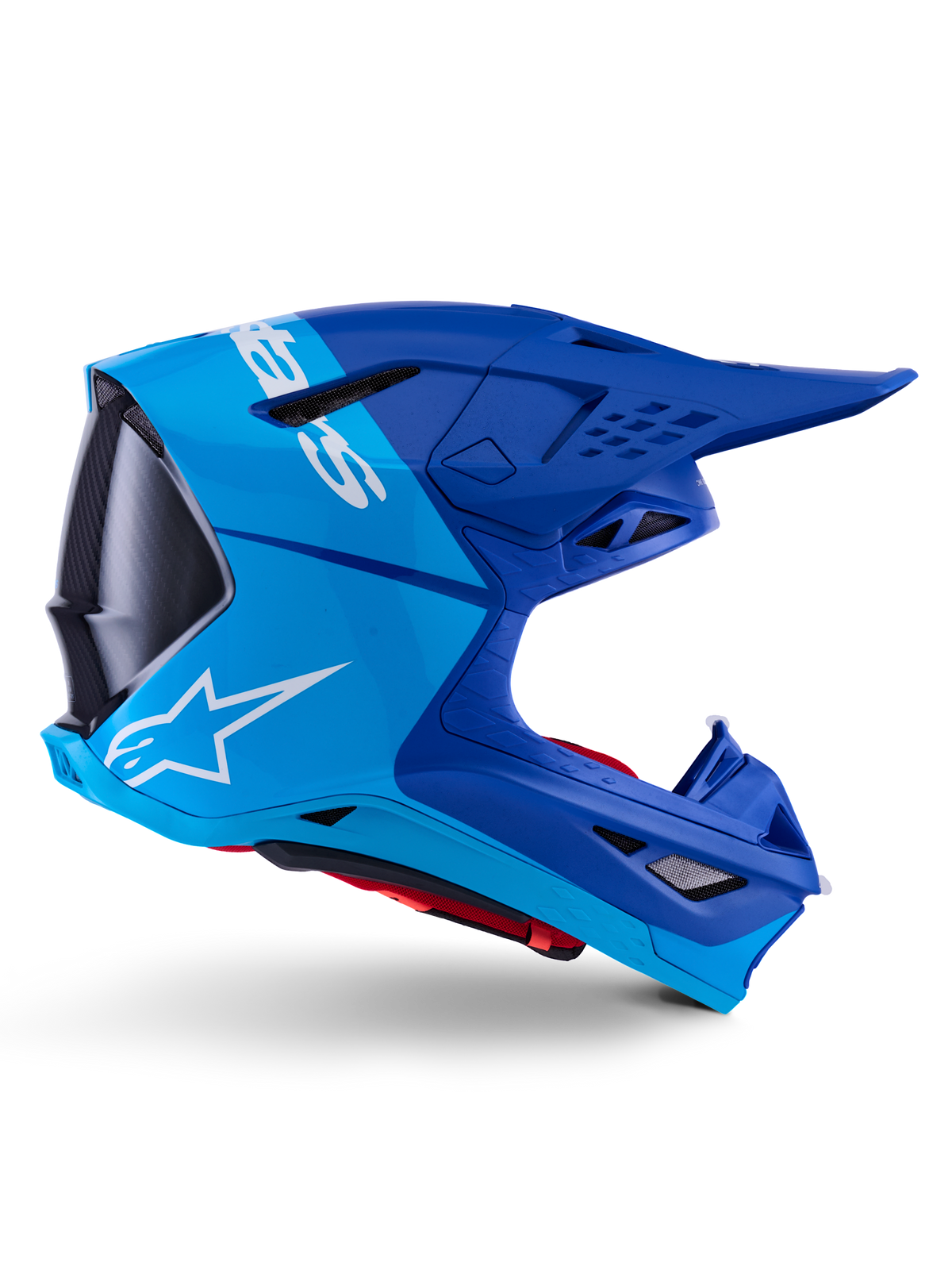 Alpinestars Supertech M10 Flood Helmet, Motocross Helmet, Metallic and Medium Blue with Black Carbon accents, side profile view, featuring a white logo, aerodynamic design with ventilation ports, carbon fiber texture details, professional off-road racing protection