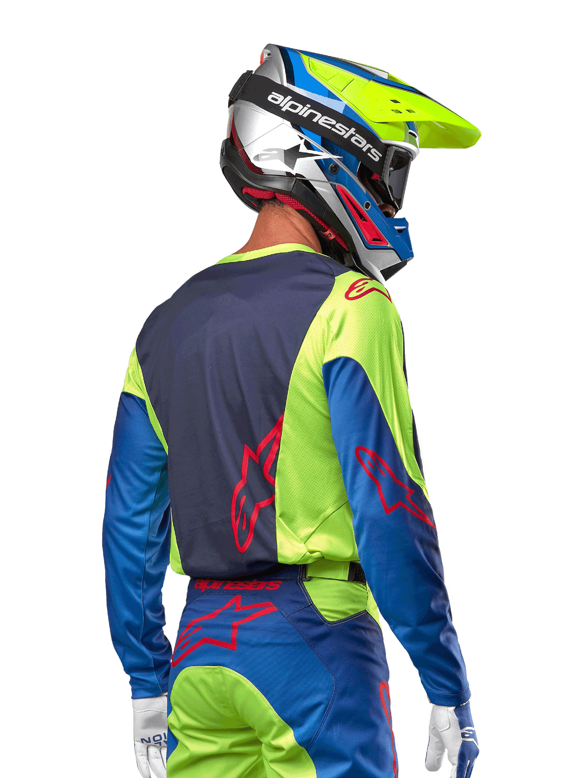 Motocross rider wearing the Alpinestars 2024 Racer Hoen Jersey in Yellow Fluo and Blue Night Navy, featuring a red star logo on the back, matching motocross pants, and a coordinated racing helmet, back view showcasing the ergonomic design for off-road performance.