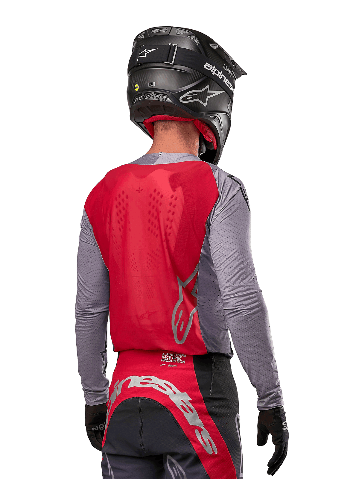 Motocross rider from behind wearing the Alpinestars 2024 Supertech Dade Jersey in Iron Red Berry and grey, featuring a breathable mesh back panel and silver logo accents, paired with a black helmet and matching racing pants for professional off-road performance