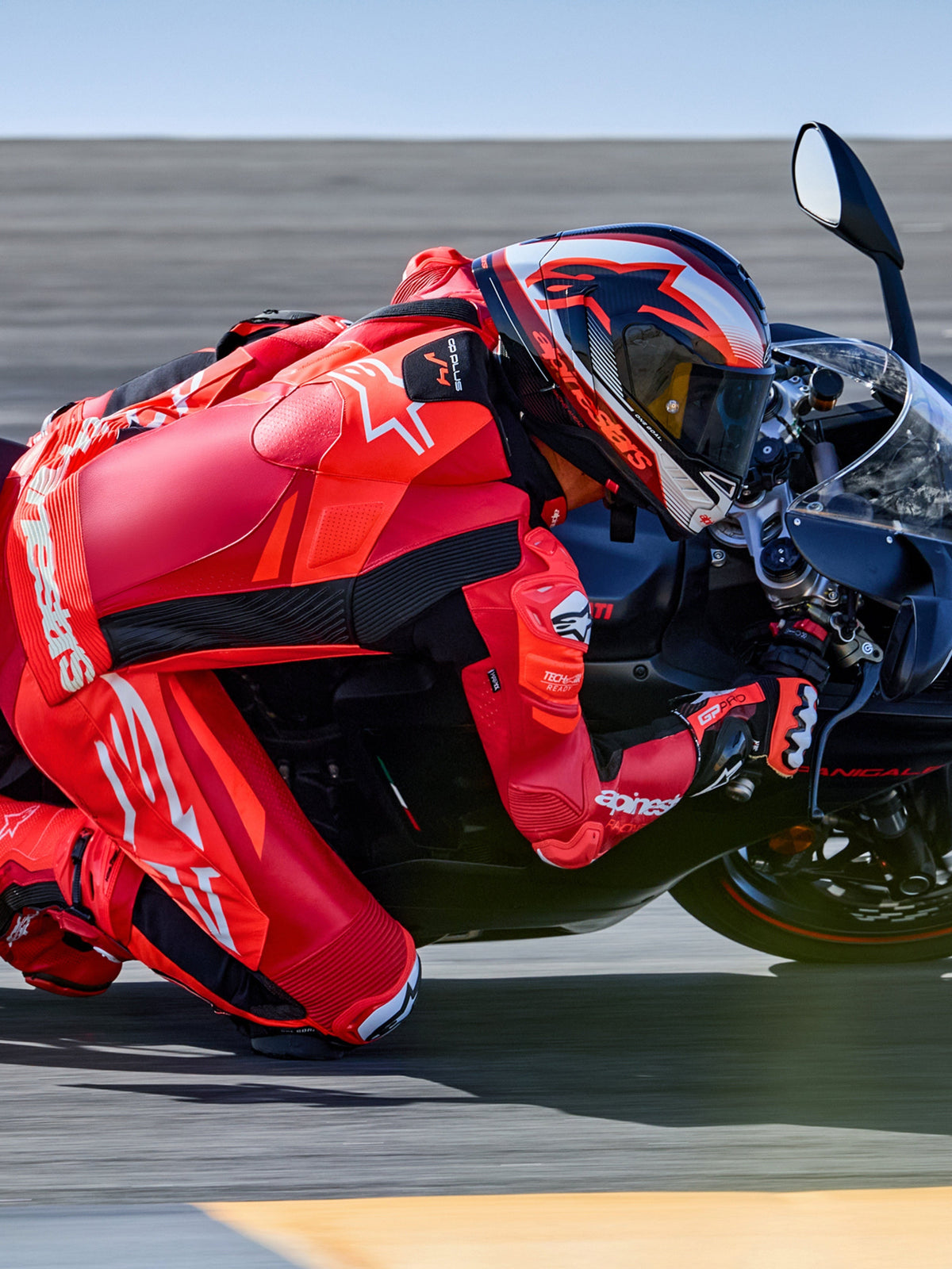 Alpinestars GP Plus V4 Sprint 1PC Leather Suit, Red Fluo and White, Tech-Air ready racing suit on rider in track turn.