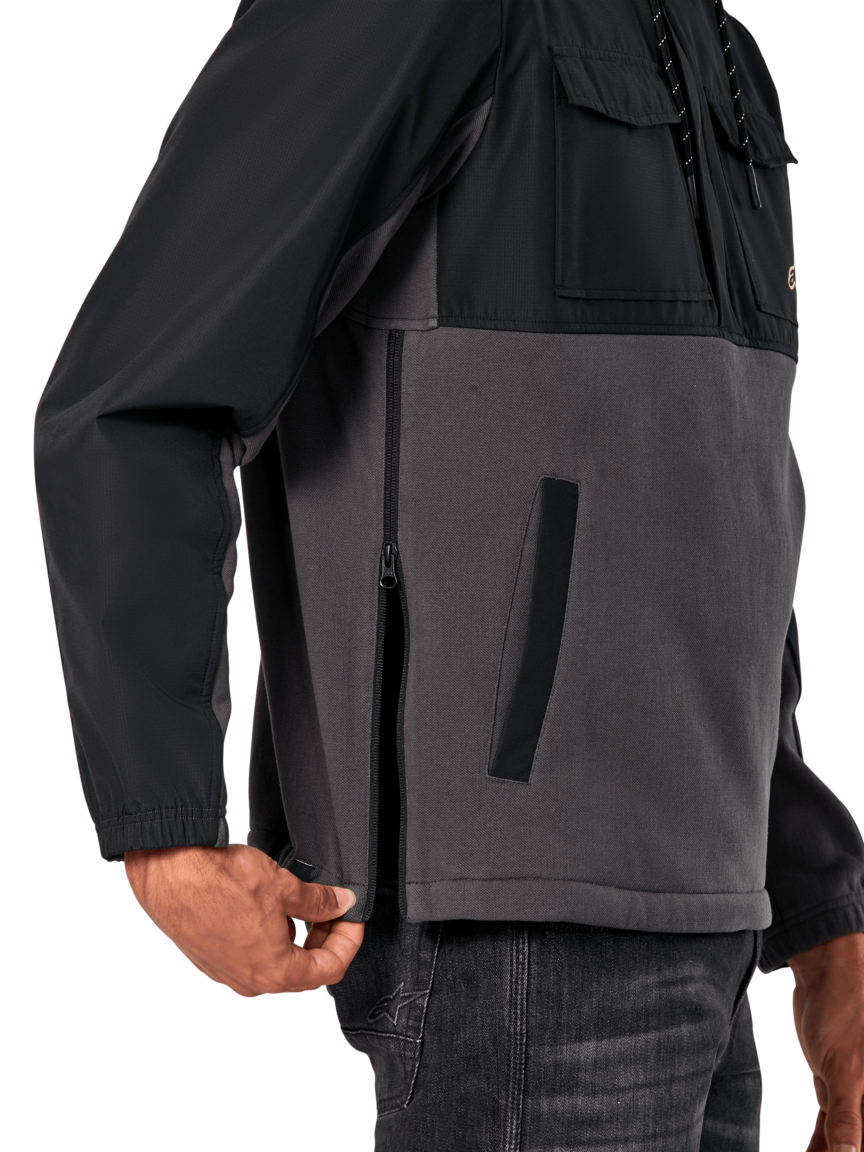 Alpinestars Juncture Hybrid Jacket in Black Gunmetal, side detail view highlighting the side entry zipper and lower welt pocket, mixed-material design with grey canvas fleece and black ripstop overlays, casual motorsport-inspired streetwear
