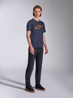 Alpinestars Ageless 2.0 CSF Tee, Short Sleeve T-Shirt, Navy Blue with Orange Star Logo, worn with dark denim jeans and black sneakers, casual motorsport-inspired streetwear
