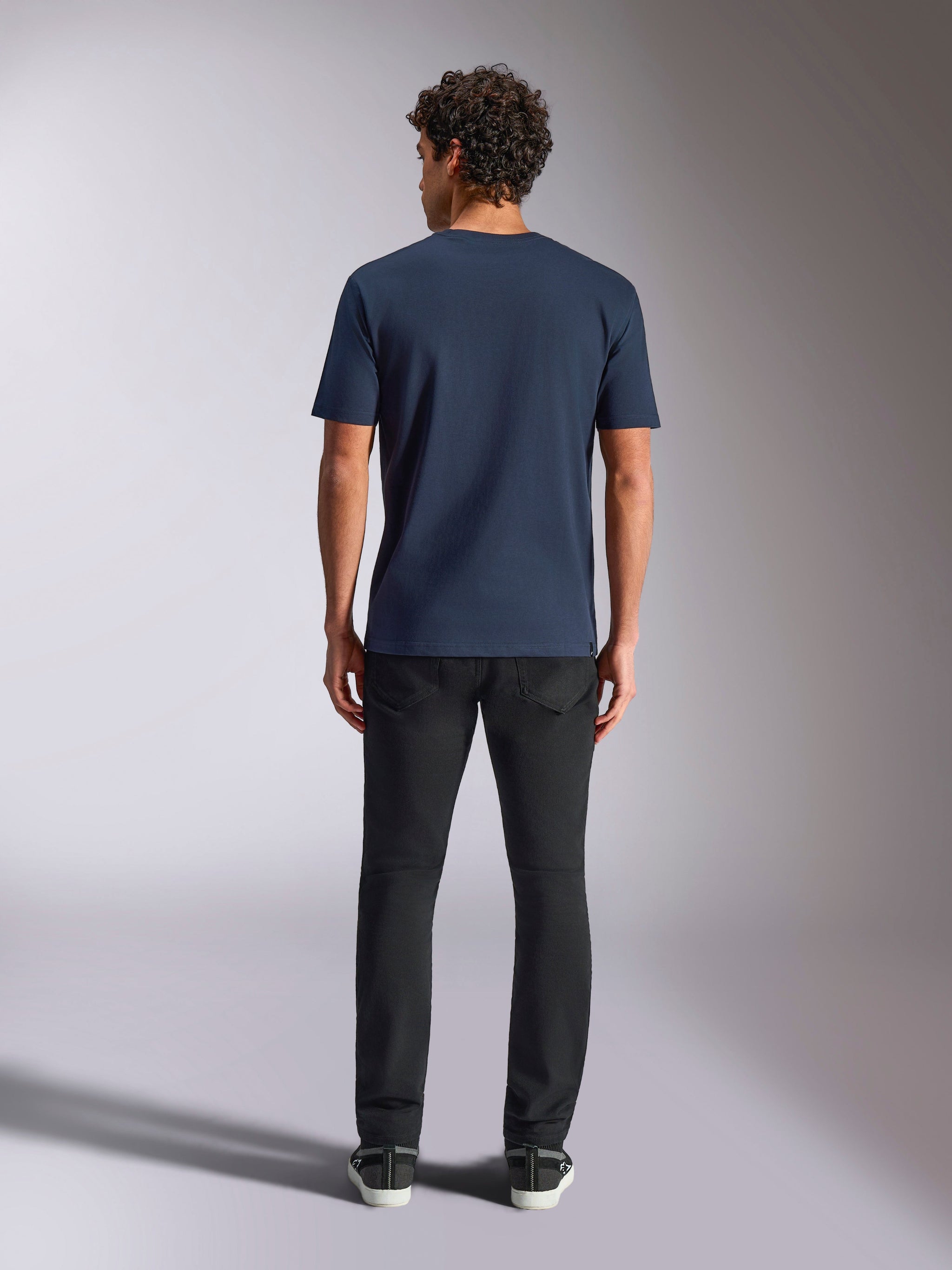 Alpinestars MX Helmet CSF Tee, Short Sleeve T-Shirt, Navy Blue, back view on model, paired with black pants, casual motorsport-inspired streetwear