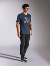 Alpinestars MX Helmet CSF Tee, Short Sleeve T-Shirt, Navy Blue, featuring white motocross helmet line art with red star logo, casual motorsport-inspired streetwear worn with black pants and high-top sneakers