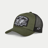 Alpinestars Heritage Patch Trucker Hat, Military Black and Olive Green, curved bill with structured crown, large embroidered front patch with vintage motorcycle wheel graphic and 'Racing Ahead' text, black mesh back with white Ageless logo on the side.