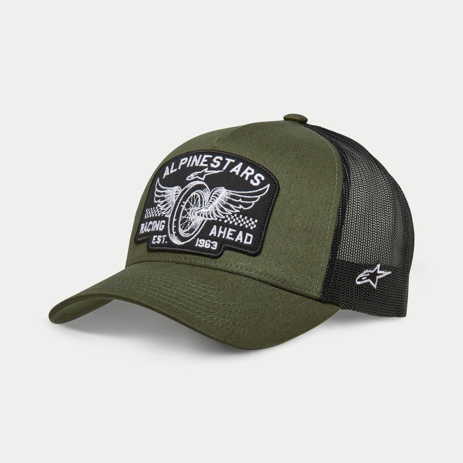 Alpinestars Heritage Patch Trucker Hat, Military Black and Olive Green, curved bill with structured crown, large embroidered front patch with vintage motorcycle wheel graphic and 'Racing Ahead' text, black mesh back with white Ageless logo on the side.