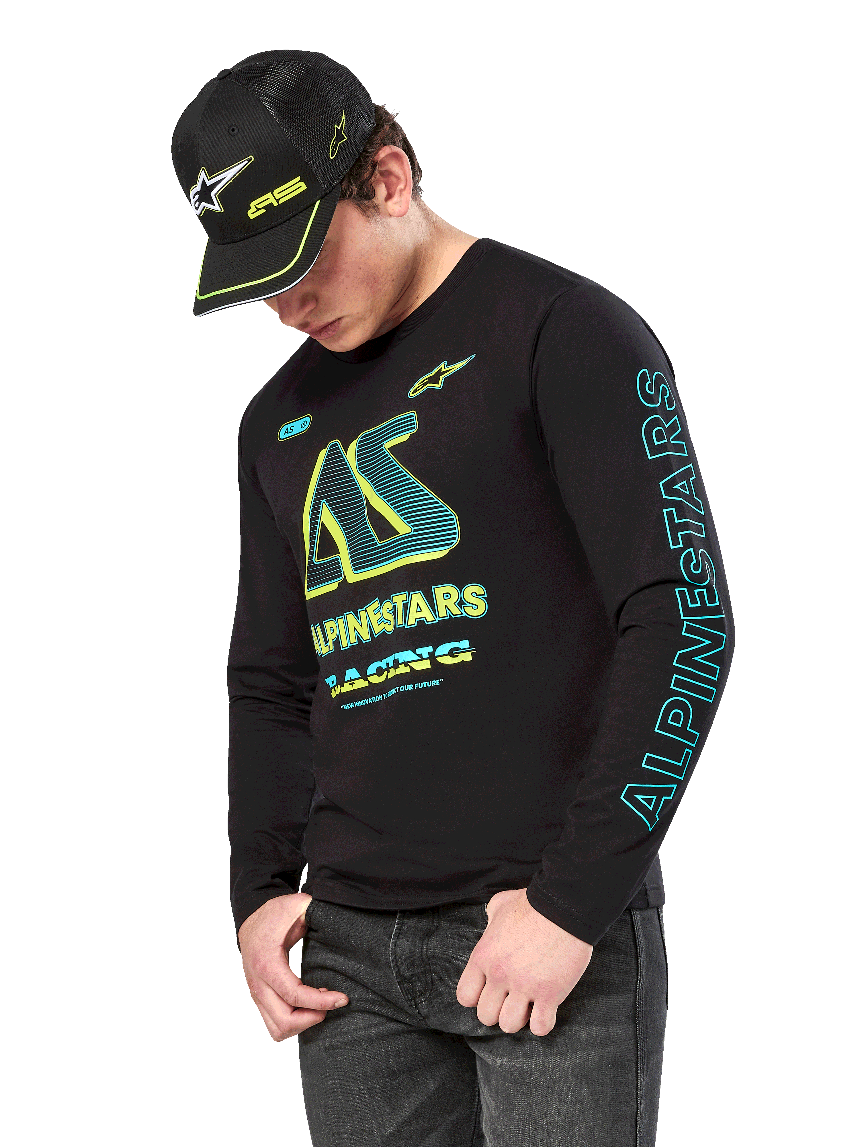 Alpinestars Ayess CSF Long Sleeve Tee, Black long sleeve shirt with neon yellow and cyan graphics, large AS chest logo and vertical Alpinestars branding on the sleeve, worn by a model with a matching black cap and dark jeans, casual motorsport lifestyle apparel
