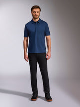 Alpinestars Impetus Sport Polo, Short Sleeve Polo Shirt, Navy Blue, small silver Astars logo on chest, three-button placket, worn by model with black pants and boots, casual motorsport-inspired sportswear