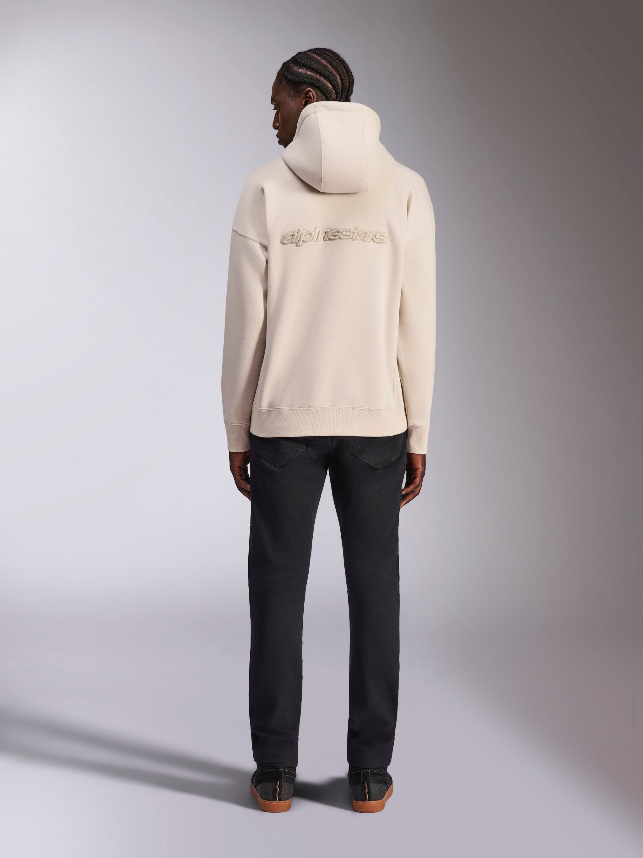 Alpinestars Emergent Oversized Hoodie, Off White, back view featuring 3D embroidered Alpinestars word logo, oversized fit fleece pullover, paired with black pants, casual streetwear design