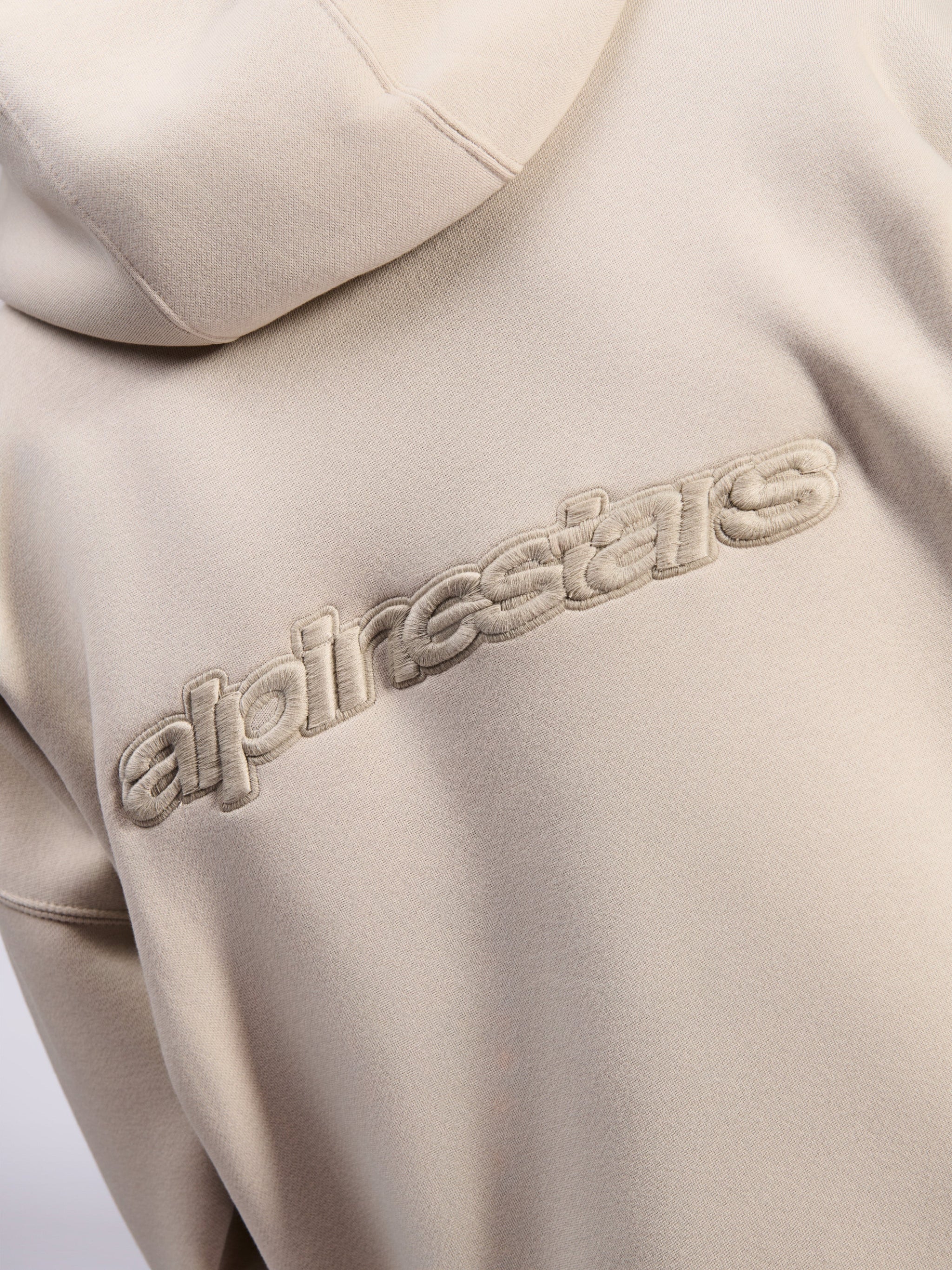 Alpinestars Emergent Oversized Hoodie, casual streetwear, Sand, detail view of tonal 3D embroidered Alpinestars word logo on the back, premium fleece texture