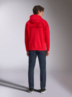 Alpinestars Emergent Oversized Hoodie, Red, back view on male model, featuring tone-on-tone 3D embroidered Alpinestars word logo, worn with dark blue jeans, casual motorsport-inspired streetwear
