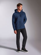 Alpinestars Emergent Oversized Hoodie, Navy Blue, worn by a male model with black pants and sneakers, featuring 3D embroidered Astars logo, kangaroo pocket, and drawstring hood, casual motorsport-inspired streetwear.