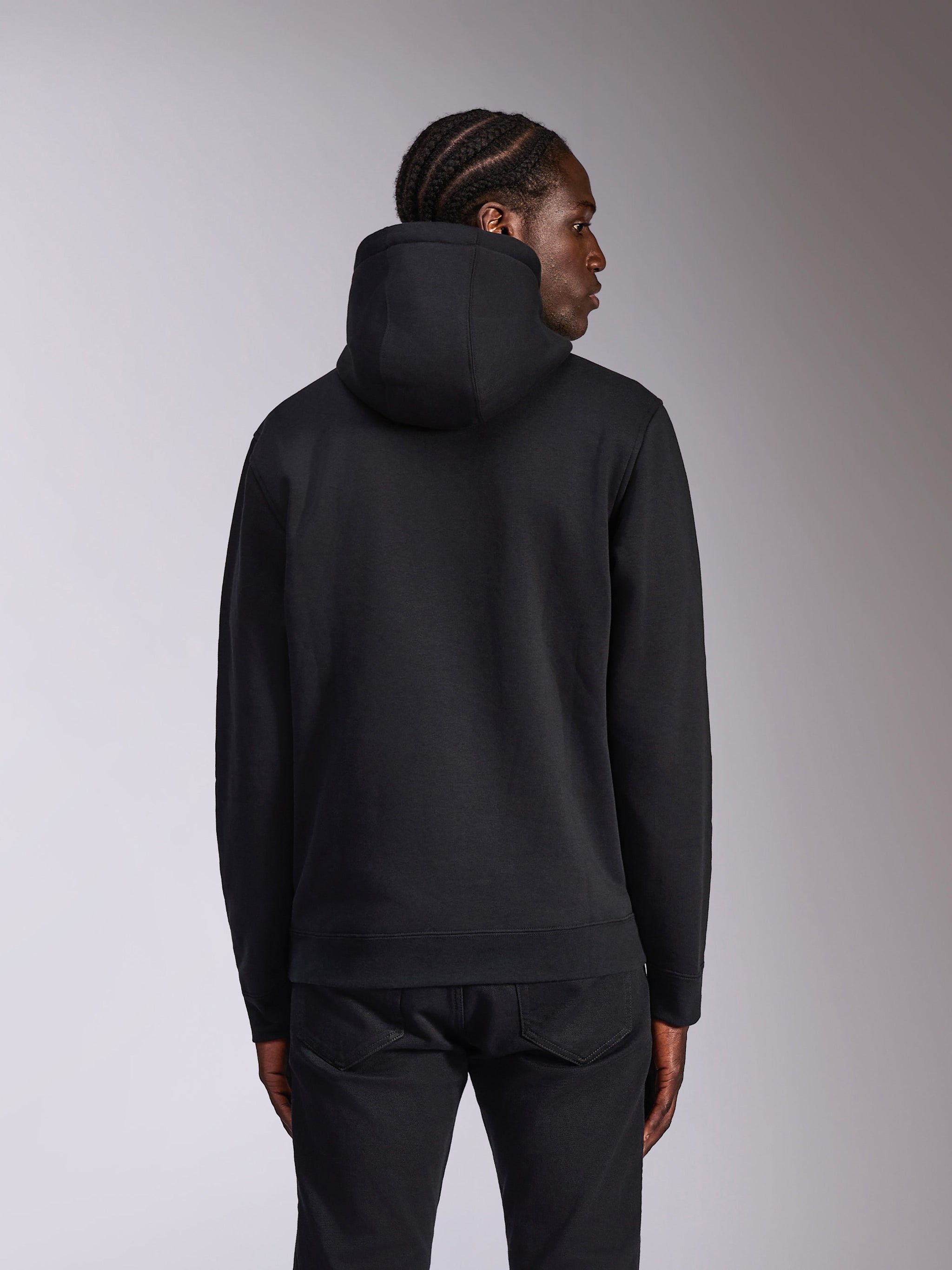 Alpinestars Pulse Hoodie, Black, back view on model, casual streetwear, hooded pullover fleece with solid black design, rib-knit cuffs and hem, paired with black pants.