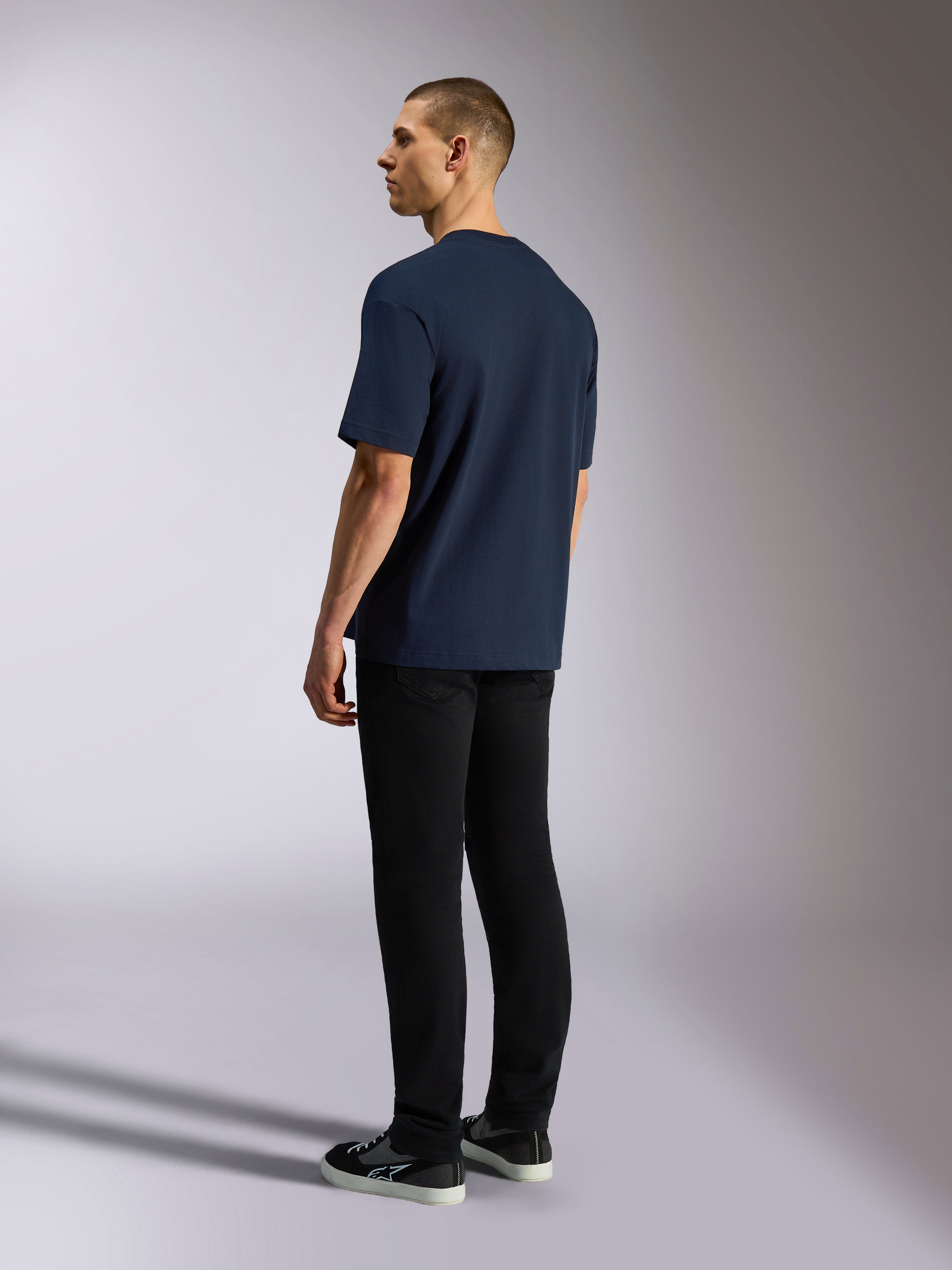 Alpinestars Aplomb Oversized CSF Tee, Short Sleeve T-Shirt, Navy, back view on model, worn with black pants and sneakers, casual motorsport-inspired streetwear