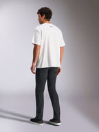 Alpinestars Focused Oversized CSF Tee, Short Sleeve T-Shirt, White, small black Alpinestars word logo on back neck, worn with black pants, oversized fit, casual motorsport-inspired streetwear