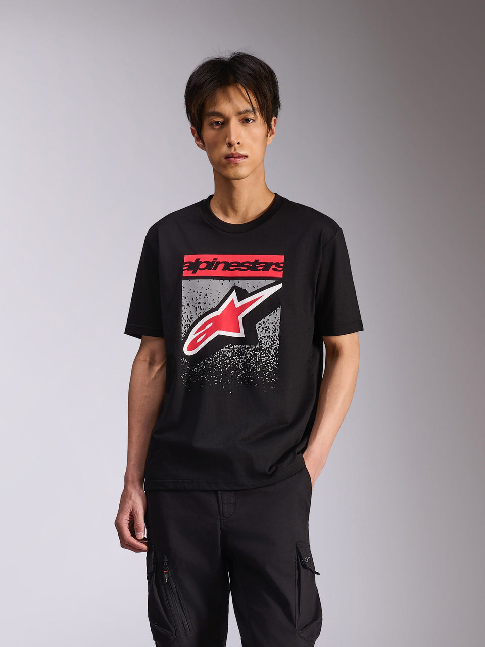 Alpinestars Noka CSF Tee, Short Sleeve T-Shirt, Black, featuring red Alpinestars text and red/white Astars logo with a grey speckled MX gradation, casual motorsport-inspired streetwear