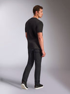 Alpinestars Trifecta CSF Tee, Short Sleeve T-Shirt, Black, rear view of a man wearing the shirt with black jeans and sneakers, casual motorsport streetwear