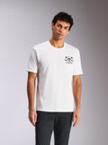 Alpinestars Order CSF Tee, Short Sleeve T-Shirt, White, Chest Graphic with Helmet and Palm Trees, worn by model with dark pants, casual motorsport-inspired streetwear