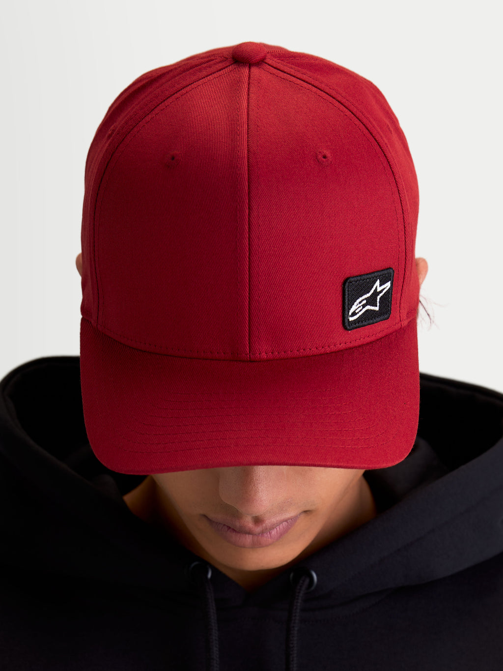 Alpinestars Pivot Hat, Casual Sportswear Baseball Cap, Dark Red, Unisex, featuring a curved bill, structured crown, and a small black Astars logo embroidered patch on durable twill fabric, on-model view.