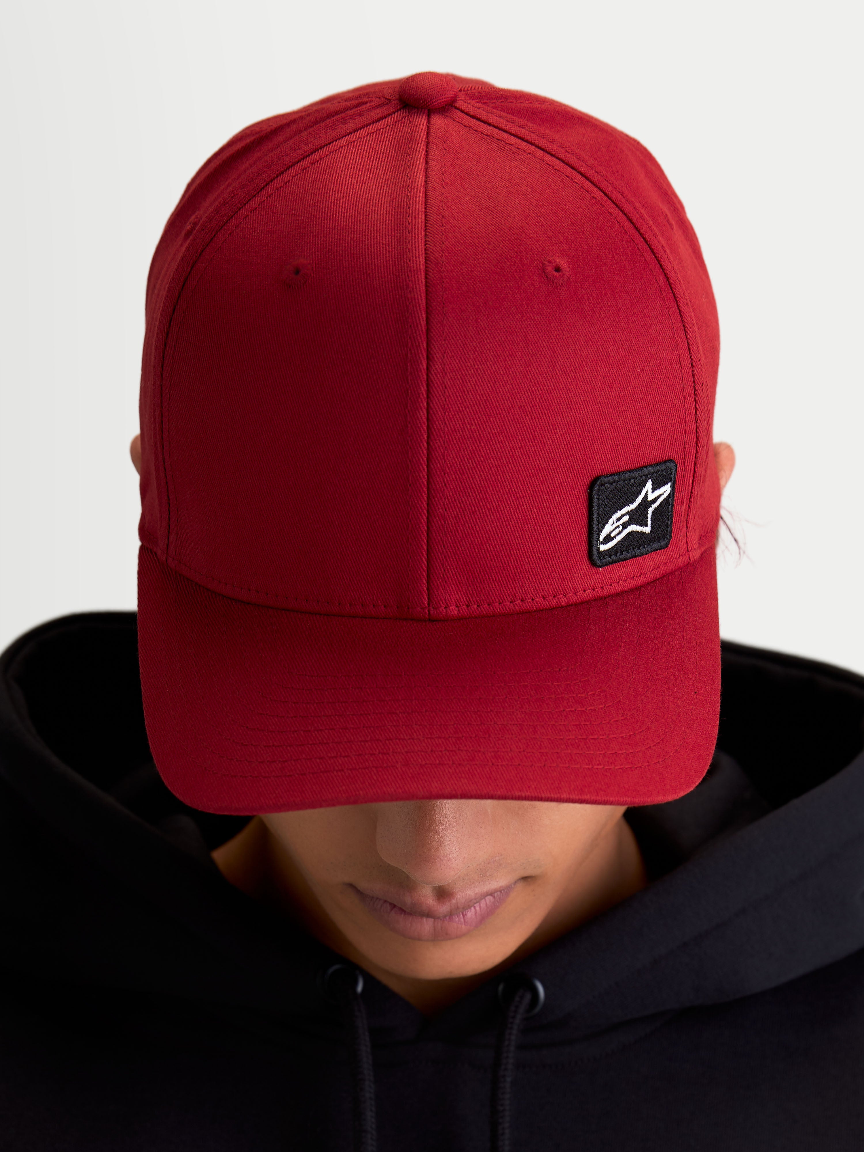 Alpinestars Pivot Hat, Casual Sportswear Baseball Cap, Dark Red, Unisex, featuring a curved bill, structured crown, and a small black Astars logo embroidered patch on durable twill fabric, on-model view.