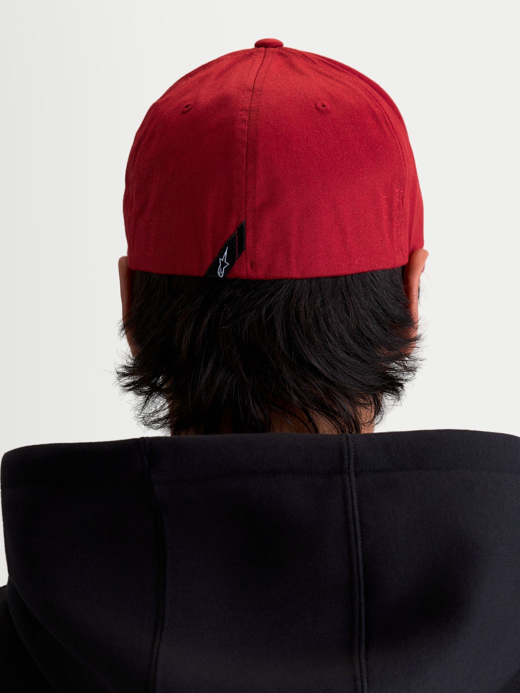 Alpinestars Pivot Hat, Dark Red Sportswear Baseball Cap, rear view on model showing the flex back construction and small Astars logo label on the back.