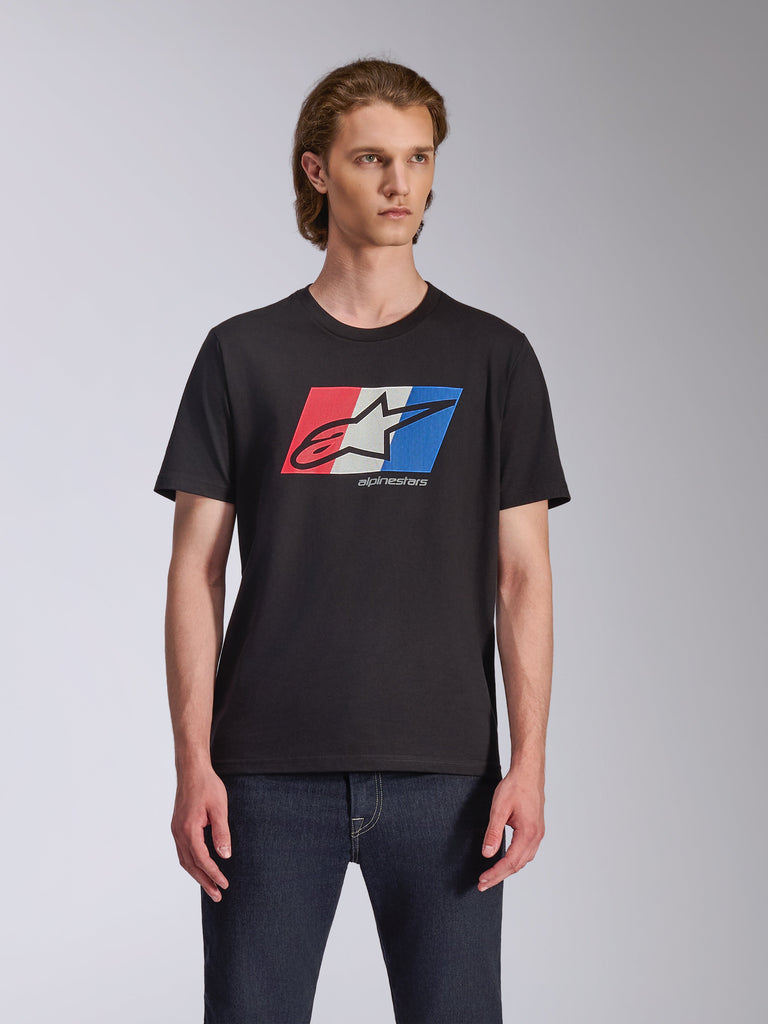 Alpinestars Global CSF Tee, Short Sleeve T-Shirt, Black, Red White and Blue Ageless logo graphic, worn by male model with dark jeans, casual motorsport streetwear