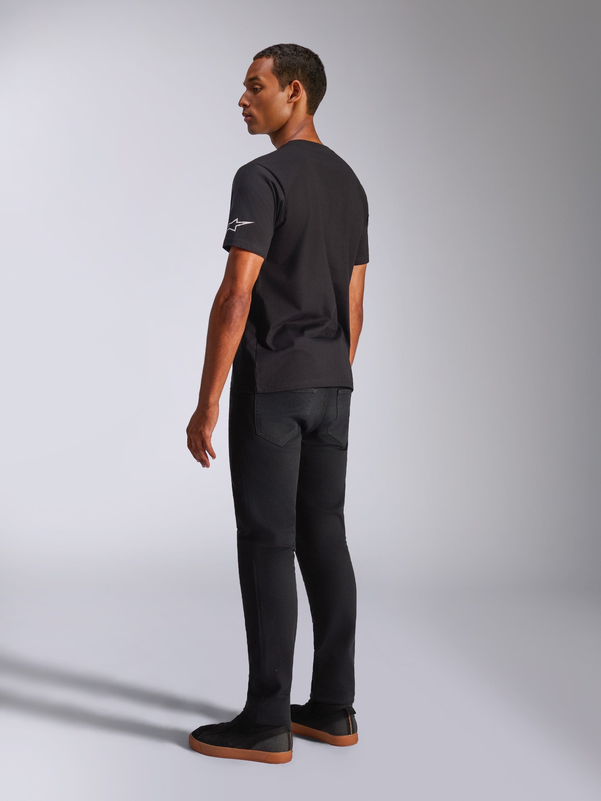 Alpinestars Waving CSF Tee, Short Sleeve T-Shirt, Black, back view showing white logo on the sleeve, worn by a model in a casual motorsport streetwear style