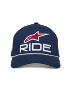 Alpinestars Ride Comp Snapback Hat, Navy Blue with White and Red accents, featuring a 3D RIDE logo, red star emblem, and white braided rope trim, curved bill, casual motorsport headwear