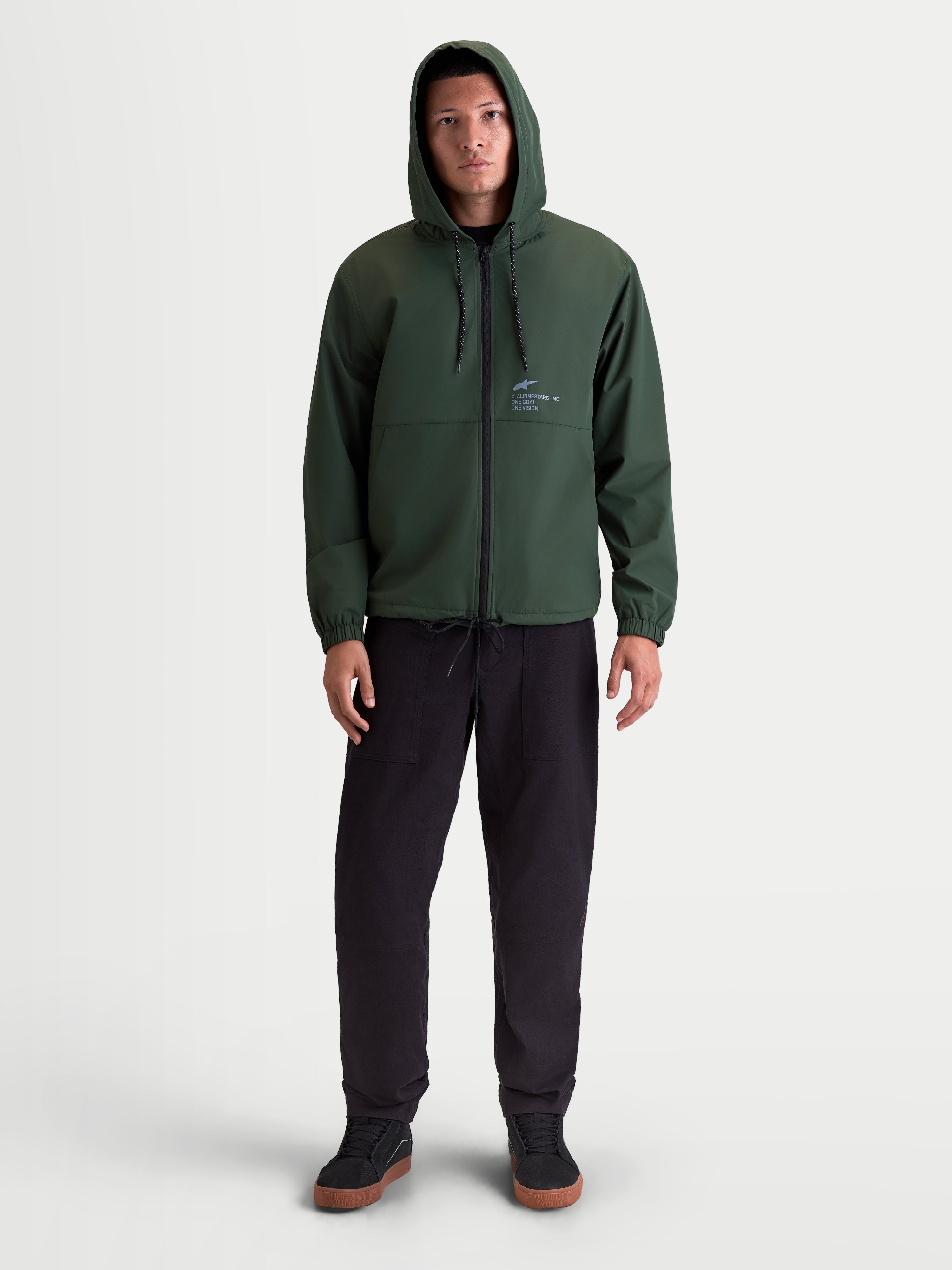 Alpinestars Speeder Resolve Windbreaker Jacket, Lightweight Sportswear Hooded Outerwear for Men and Women, Pine Green, 100% Polyester, featuring adjustable hood, reverse-coil zipper, and signature Alpinestars branding, on-model front view