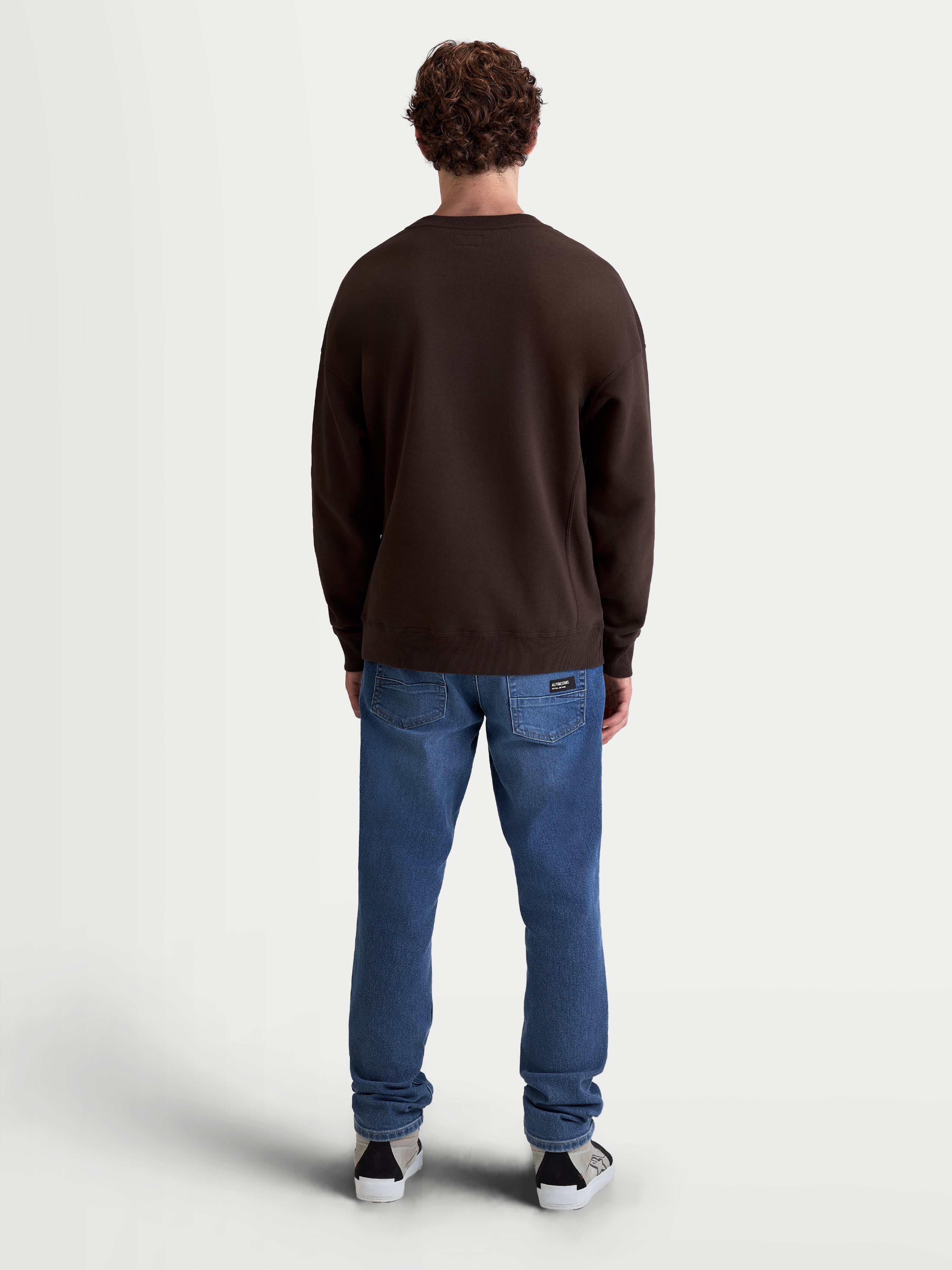 Alpinestars Guise Oversized Crew, Sportswear Fleece Pullover, Brown, Unisex, Oversized Relaxed Fit, Back View on Model, Cotton and Recycled Polyester Blend, Ribbed Cuffs and Hem.