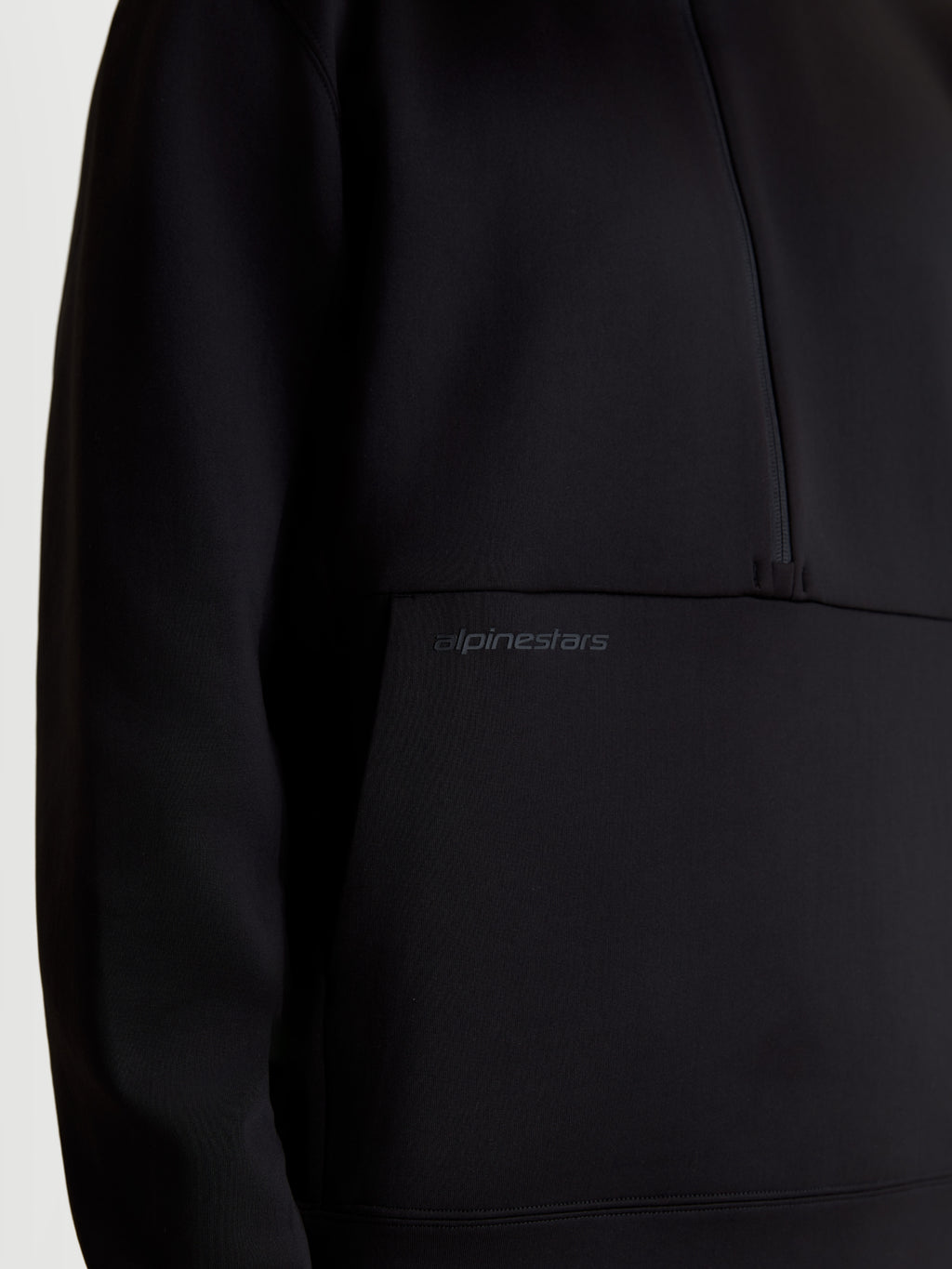 Alpinestars Apera Half-Zip Sweatshirt, Sportswear Pullover for Men and Women, Black, close-up showing the tonal HD logo print on the kangaroo pocket and half-zip design, premium tri-blend fleece construction.